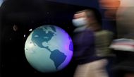 People walk past a mode of the earth during the UN Climate Change Conference (COP26) in Glasgow, Scotland, Britain, October 31, 2021. REUTERS/Yves Herman