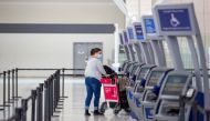 FILE PHOTO: A person wearing a protective mask walks through terminal 1 at Toronto's Pearson Airport after mandatory coronavirus disease (COVID-19) testing took effect for international arrivals in Mississauga, Ontario, Canada February 15, 2021. REUTERS/Carlos Osorio

