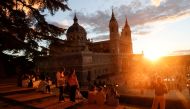 Tourists and locals watch the sunset by La Almudena Cathedral in Madrid, Spain, October 3, 2021. REUTERS/Susana Vera/File Photo