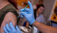 A doctor vaccinates a woman with a coronavirus disease (COVID-19) vaccine, in his doctor's office in Berlin, Germany, November 2, 2021. REUTERS/Hannibal Hanschke