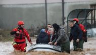 Rescue workers speak with people on a flooded street in Otes near Sarajevo, Bosnia and Herzegovina November 5, 2021. REUTERS/Dado Ruvic