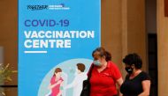 People walk outside a vaccination centre at the University of Malta, after authorities announced that Malta had achieved herd immunity with 70% of the population being receiving at least one vaccine dose against the coronavirus disease (COVID-19), in Msida, Malta May 24, 2021. REUTERS/Darrin