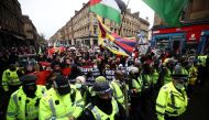 Police officers keep guard as demonstrators attend a protest amid the UN Climate Change Conference (COP26), in Glasgow, Scotland, Britain, November 6, 2021. Reuters/Hannah McKay
