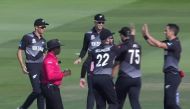 New Zealand players celebrating the fall of a wicket. 