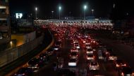 Cars wait in line to cross into the US, ahead of the Mexico-U.S. border reopening in Tijuana, Mexico November 7, 2021. Reuters/Toya Sarno Jordan