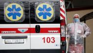 A health worker stands near an ambulance carrying a COVID-19 patient, as they wait in the queue at a hospital for people infected with the coronavirus disease in Kyiv, Ukraine October 18, 2021. REUTERS/Gleb Garanich
