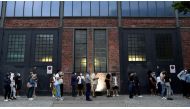 People queue to receive a vaccine against the coronavirus disease (COVID-19), during a night of vaccinations with music, at the Arena Treptow vaccination centre in Berlin, Germany, August 9, 2021. John Macdougall/Pool via REUTERS
