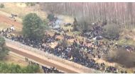 Hundreds of migrants are seen on the Belarus side of the border with Poland, guarded by the Polish soldiers near Kuznica Bialostocka, Poland, in this video-grab released by the Polish Defence Ministry, November 8, 2021.