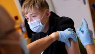 A doctor vaccinates a 13-year-old boy with a coronavirus disease (COVID-19) vaccine, in his doctor's office in Berlin, Germany, November 2, 2021. REUTERS/Hannibal Hanschke/File Photo