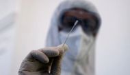 A healthcare worker in protective equipment is seen at a rapid antigen mass testing station, as the spread of the coronavirus disease (COVID-19) continues, in Vienna, Austria, February 3, 2021. REUTERS/Leonhard Foeger/File Photo

