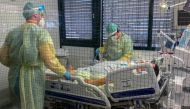 Medical staff members of Munchen Klinik Schwabing hospital take care of a patient infected with the coronavirus disease (COVID-19) in the intensive care unit in Munich, Germany, November 12, 2021. REUTERS/Ayhan Uyanik