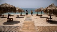 Workers install wooden corridors on a beach, a day before the official opening of beaches to the public following the easing of measures against the spread of the coronavirus disease (COVID-19), in Athens, Greece, May 15, 2020. REUTERS/Alkis Konstantinidis/File Photo