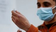 A pharmacist prepares a COVID-19 vaccine in Northampton, Britain, October 21, 2021. REUTERS/Andrew Boyers

