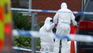 A police officer searching an area puts an item into a box at the scene of a car blast outside Liverpool Women's Hospital, in Liverpool, Britain, November 15, 2021. REUTERS/Phil Noble