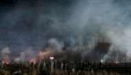 Polish service members stand guard next to a barbed wire fence on the frontier, as hundreds of migrants gather on the Belarusian side of the border with Poland in an attempt to cross it, near Kuznica Bialostocka, Poland, in this handout picture released by the Polish Defence Ministry, November 9, 2021. 