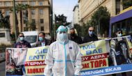 A health worker wearing personal protective equipment walks during a health sector workers' protest as Greek hospitals are under pressure due to escalating coronavirus disease (COVID-19) cases, in Athens, Greece, November 15, 2021. REUTERS/Louiza Vradi TPX IMAGES OF THE DAY

