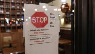 A '2G' rule sign, allowing only those vaccinated or recovered from the coronavirus disease (COVID-19) to enter restaurants and other indoor areas, is displayed at the entrance of a restaurant in Berlin, Germany, November 15, 2021. REUTERS/Annegret Hilse
