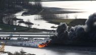 RV trailers burn in a storage yard after rainstorms caused widespread flooding and landslides in Abbotsford, British Columbia, Canada, November 17, 2021. Reuters/Jesse Winter