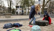 Children are seen leaving school on a Friday after a nation-wide ban on large public gatherings to avoid coronavirus spreading in Amsterdam, Netherlands March 13, 2020. REUTERS/Eva Plevier

