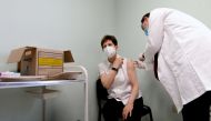FILE PHOTO: Healthcare worker Adrienne Kertesz receives a dose of the Pfizer-BioNTech COVID-19 vaccine at the Del-Pest Central Hospital as the coronavirus disease (COVID-19) outbreak continues, in Budapest, Hungary, December 26, 2020. Szilard Koszticsak/Pool via REUTERS/File Photo
