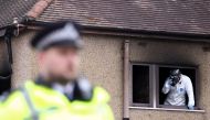 An investigator inspects the scene of a house fire in Bexleyheath, London, Britain November 19, 2021. REUTERS/Tom Nicholson