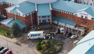 Police forensic officers stand near the remains of a taxi that exploded outside Liverpool Women's Hospital in Liverpool, Britain, November 17, 2021. Picture taken with a drone. REUTERS/Phil Noble


