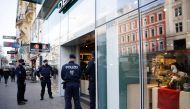 Police officers check the vaccination status of shoppers at the entrance of a store after the Austrian government imposed a lockdown on the roughly two million people who are not fully vaccinated against the coronavirus disease (COVID-19) in Vienna, Austria, November 16, 2021. Reuters/Lisi Niesner