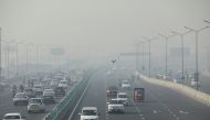 Vehicles are seen shrouded in smog on a highway in New Delhi, India, November 18, 2021. REUTERS/Anushree Fadnavis/File Photo