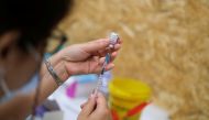 FILE PHOTO: A healthcare worker prepares a dose of the Pfizer coronavirus disease (COVID-19) vaccine at a vaccination centre in Seixal, Portugal, September 11, 2021. REUTERS/Pedro Nunes/File Photo
