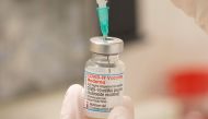 FILE PHOTO: A health care worker fills up a syringe with a dose of Moderna's COVID-19 vaccine for a booster shot at the vaccination reference center at the Epidemiology, Biostatistics and Prevention Institute (EBPI) in Zurich, Switzerland November 17, 2021. REUTERS/Arnd Wiegmann/File Photo
