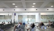 People sit in the arrivals section of the international terminal of Kingsford Smith International Airport. Reuters/Loren Elliott
