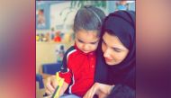 A young Qatar Academy Doha pupil with a teacher.