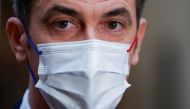 French Health Minister Olivier Veran talks to journalists after his visit to a coronavirus disease (COVID-19) vaccination center in Paris, France, November 28, 2021. REUTERS/Gonzalo Fuentes
