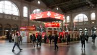 FILE PHOTO: People walk at the so-called 'vaccination village' (Impfdorf) after the start of a countrywide COVID-19 vaccination week against the coronavirus disease, in the hall of the central railway station, in Zurich, Switzerland November 8, 2021. REUTERS/Arnd Wiegmann/File Photo
