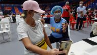Wendilyn Cabornay, 65, takes a selfie while being inoculated at a vaccination centre in San Juan City, Metro Manila, in the Philippines, November 29, 2021. Reuters/ Peter Blaza
