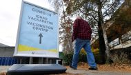 A man walks past a sign for the coronavirus disease (COVID-19) vaccination centre at University College Dublin (UCD) campus clinic for inoculating frontline workers in Dublin, Ireland, November 28, 2021. Reuters/Clodagh Kilcoyne