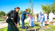Natalie Baker, Chargé d’Affaires at US Embassy in Qatar, and other officials planting a tree under QBG’s ‘Ghars’ campaign, marking campaign’s 2000th tree, at Qur’anic Botanic Garden.  