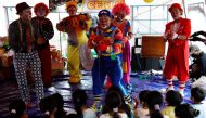 Dedy Rachmanto, 53, known as Dedy Delon who is the founder of a clowns' association called Aku Badut Indonesia or 'I Indonesia Clown', perform a show with other clowns to cheer the children who were affected by the eruption of Mount Semeru volcano, inside a temporary tent in Penanggal, Candipuro district, Lumajang, East Java province, Indonesia, December 9, 2021. REUTERS/Willy Kurniawan
