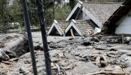 Houses that submerged with lava are seen in Kamar Kajang, an area affected by the eruption of Mount Semeru volcano, in Candipuro district, Lumajang, East Java province, Indonesia, December 9, 2021. REUTERS/Willy Kurniawan