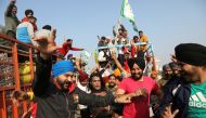 Farmers dance as they vacate a protest site, after the government agrees to their demands, including assurance to consider guaranteed prices for all produce, at the Singhu border near New Delhi, India, December 11, 2021. REUTERS/Anushree Fadnavis