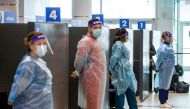 Healthcare workers prepare to test passengers as they arrive at Toronto's Pearson airport after mandatory coronavirus disease (COVID-19) testing took effect for international arrivals in Mississauga, Ontario, Canada February 1, 2021. REUTERS/Carlos Osorio/File Photo