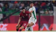 Karim Boudiaf vies for the ball possession with Baghdad Bounedjah of Algeria.