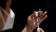 FILE PHOTO: A healthworker prepares a dose of COVID-19 vaccine for protection against the coronavirus disease at a cinema turned into a temporary vaccination site in San Juan, Metro Manila, Philippines, December 15, 2021. REUTERS/Eloisa Lopez/File Photo
