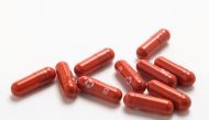 FILE PHOTO: An experimental COVID-19 treatment pill, called molnupiravir and being developed by Merck & Co Inc and Ridgeback Biotherapeutics LP, is seen in this undated handout photo released by Merck & Co Inc and obtained by Reuters on October 26, 2021. Merck & Co Inc/Handout via REUTERS