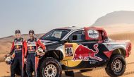 Qatar's Nasser Al Attiyah and his French co-driver Matheiu Baumel pose for a photograph in front of their Toyota GR DKR Hilux T1+ ahead of the 2021 Dakar Rally.