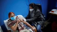 A woman receives a booster dose of Covaxin, a coronavirus disease (COVID-19) vaccine manufactured by Bharat Biotech, at a vaccination centre in New Delhi, India, January 10, 2022. REUTERS/Adnan Abidi


