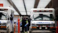 Ambulance crew members deliver a patient at Mount Sinai Hospital as officials warned of a 