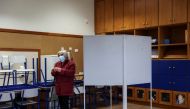 A women prepares to cast her vote at a polling station during the general election in Lisbon, Portugal, January 30, 2022. REUTERS/Rodrigo Antunes