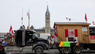 Vehicles displaying protest signs are seen outside Parliament Hill, as demonstrations by truckers and their supporters against the coronavirus disease (COVID-19) vaccine mandates continue, in Ottawa, Ontario, Canada, January 31, 2022. REUTERS/Blair Gable
