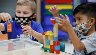 FILE PHOTO: Children wear a masks and wait for U.S. President Joe Biden to visit her pre-Kindergarten class at East End Elementary School to highlight the early childhood education proposal in his Build Back Better infrastructure agenda in North Plainfield, New Jersey, U.S. October 25, 2021. REUTERS/Jonathan Ernst/File Photo
